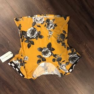 yellow shirt with black and with flowers